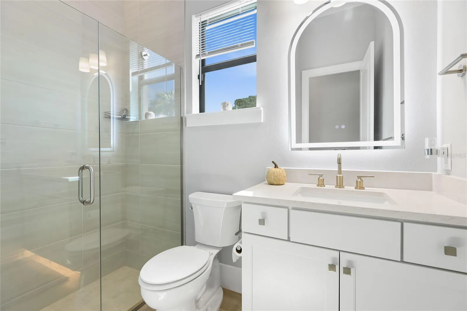Bathroom 2 with walk-in shower and under lighting cabinetry, illuminating mirror.