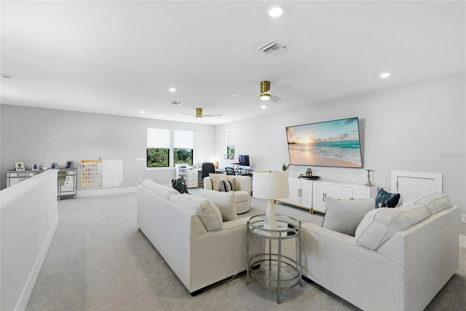 Light-filled bonus room featuring ample windows and transom windows, offering a versatile space ideal for a second TV room, home office, or additional gathering area—perfect for entertaining guests and enjoying quality time with family