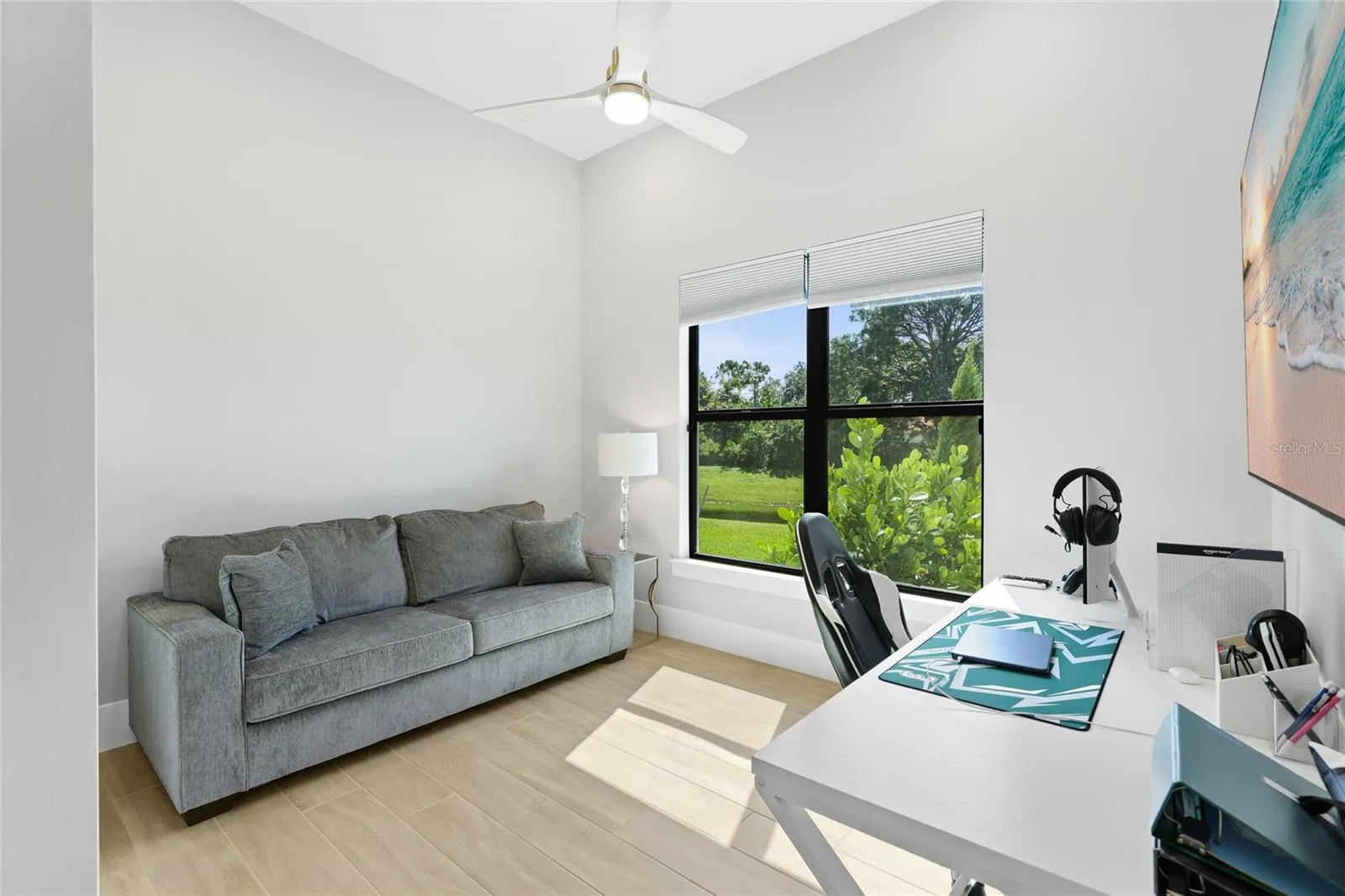 Bedroom 3 with ceiling fan, built-in closet with lighting.