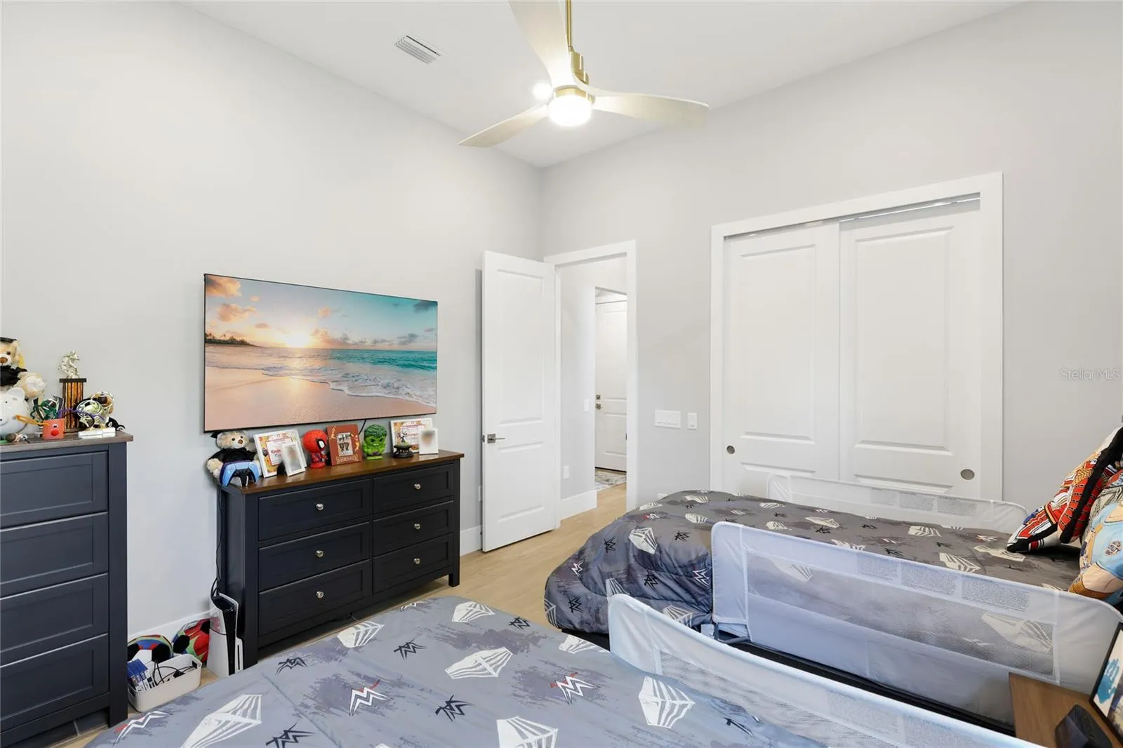 Bedroom 4 with ceiling fan, built-in closet with lighting.