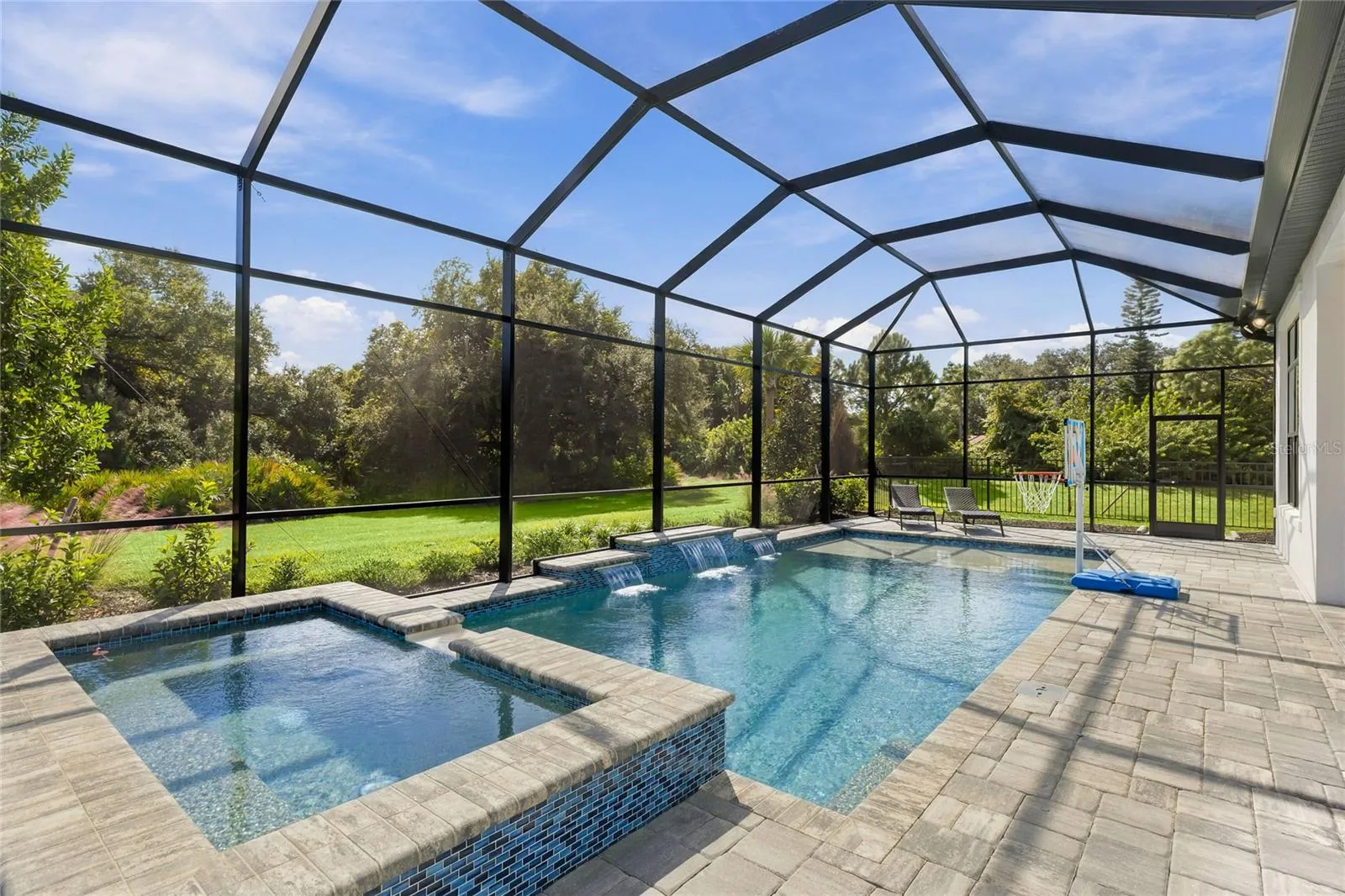 Custom Saltwater Pool with expansive spillover Spa, additional water features and Pool Shelf.