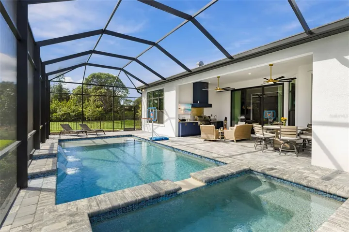 Custom Saltwater Pool with expansive spillover Spa, additional water features and Pool Shelf.