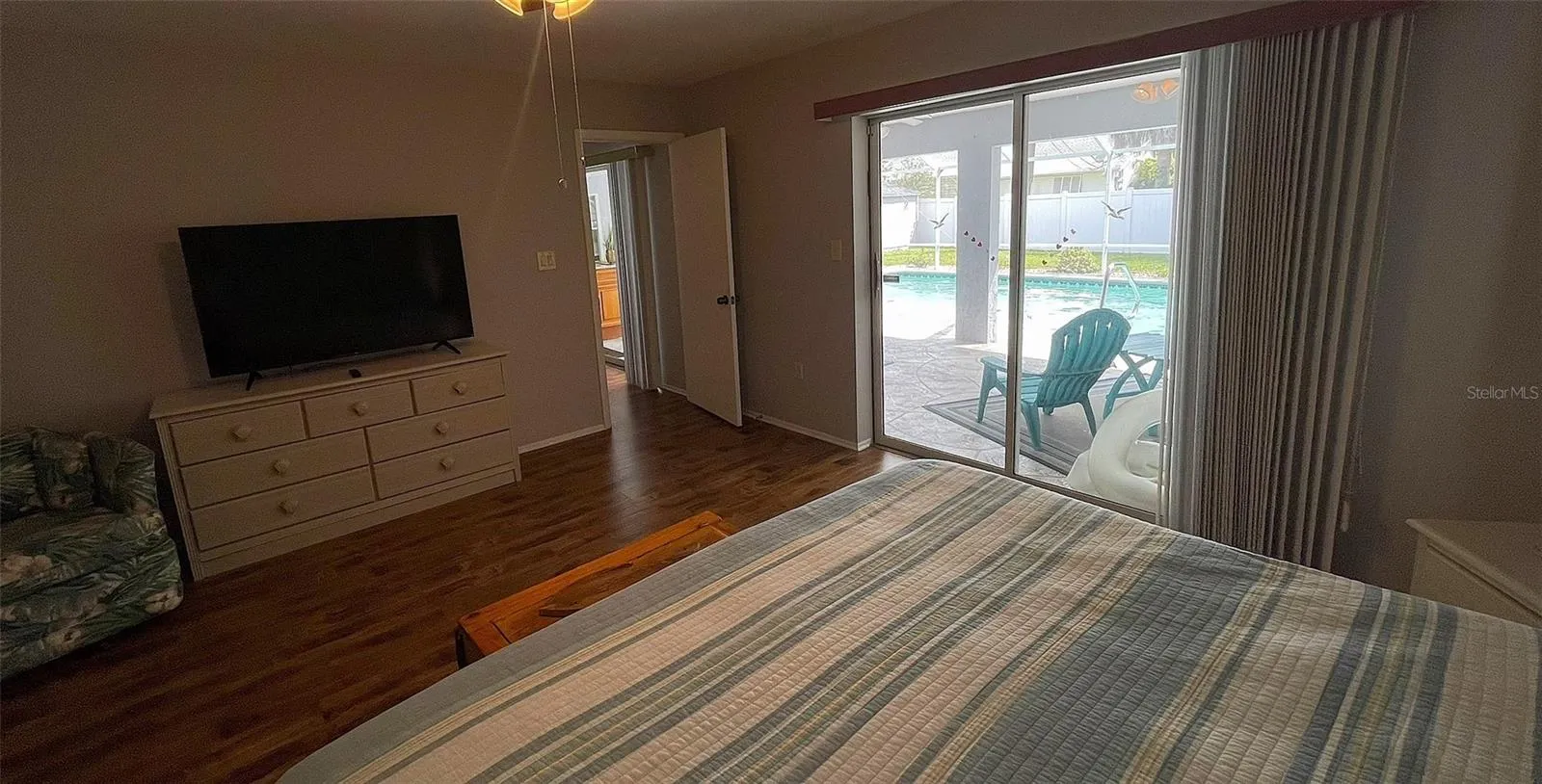 Primary bedroom w/ access to lanai & pool.