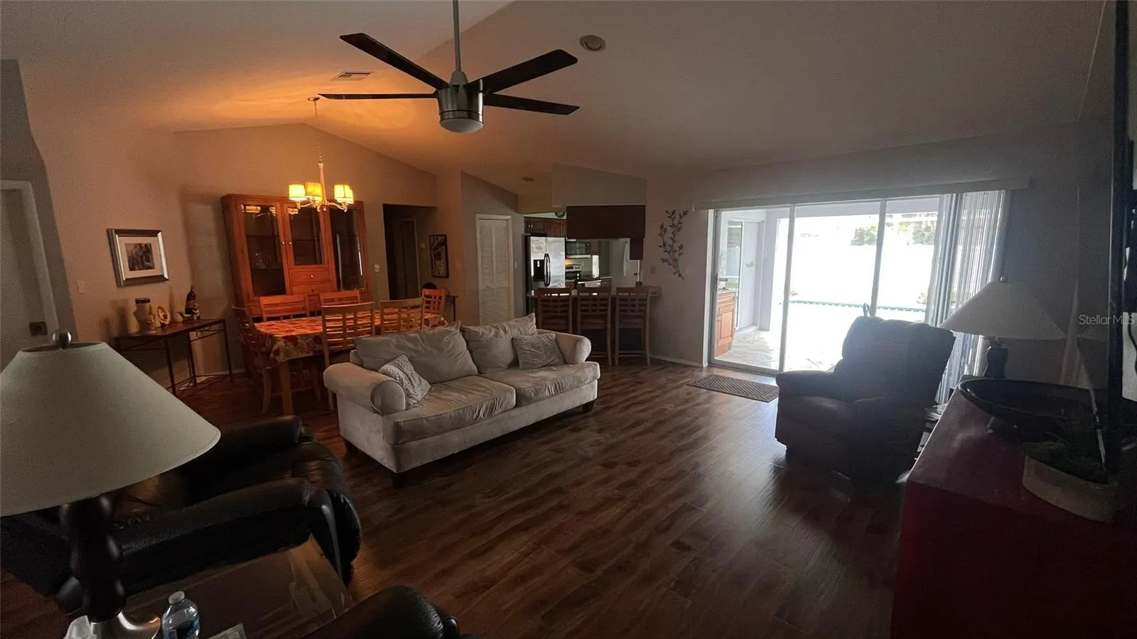 Living room with access to the lanai and pool.