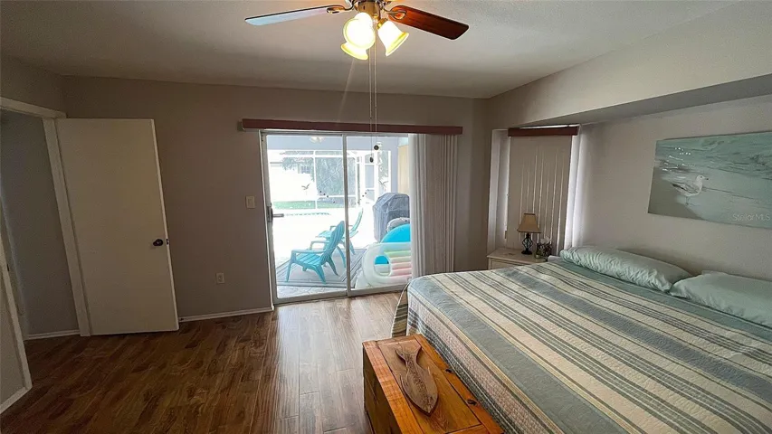 Primary bedroom w/ access to lanai & pool.