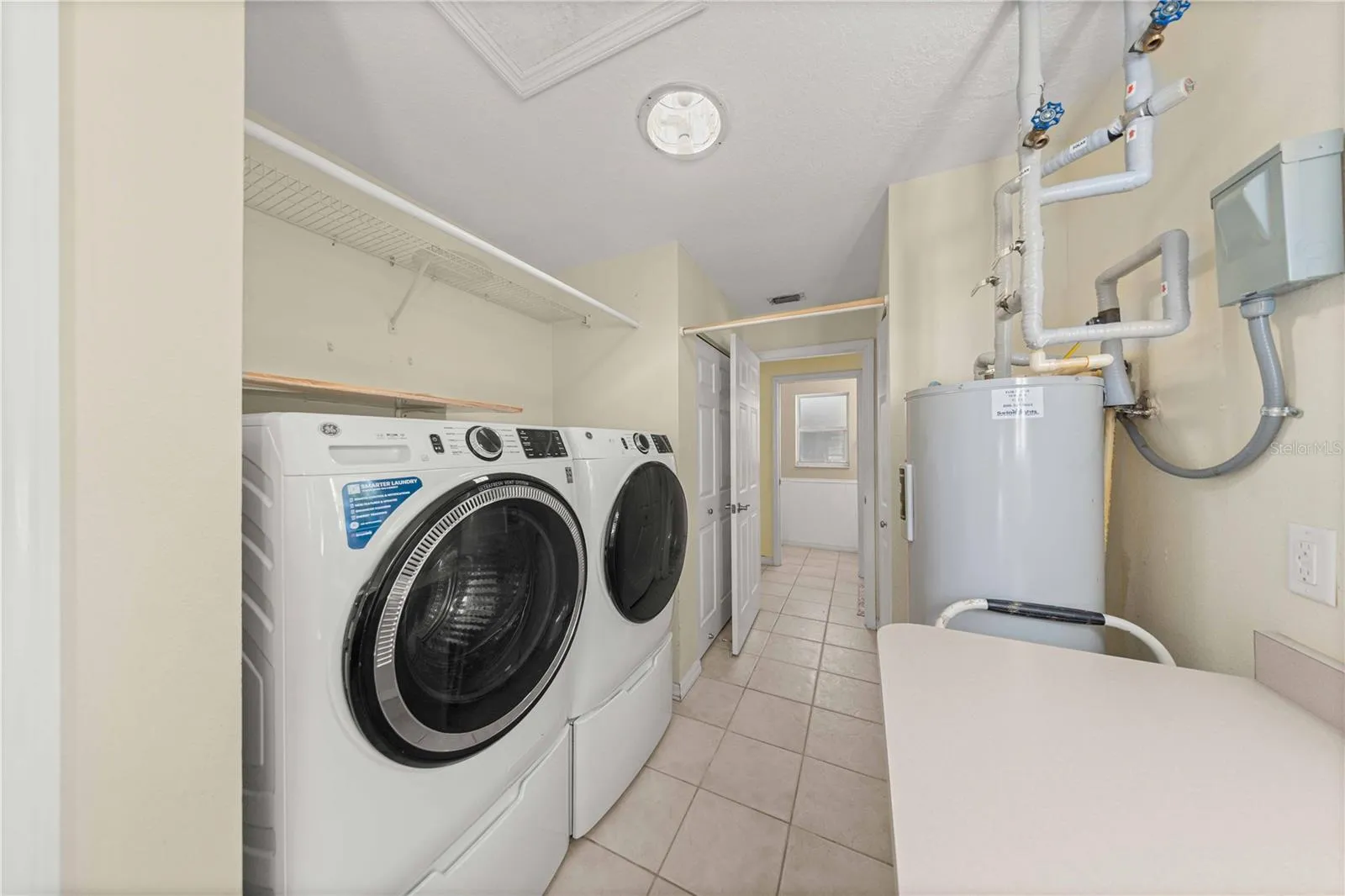 Laundry room with pantry and storage closet