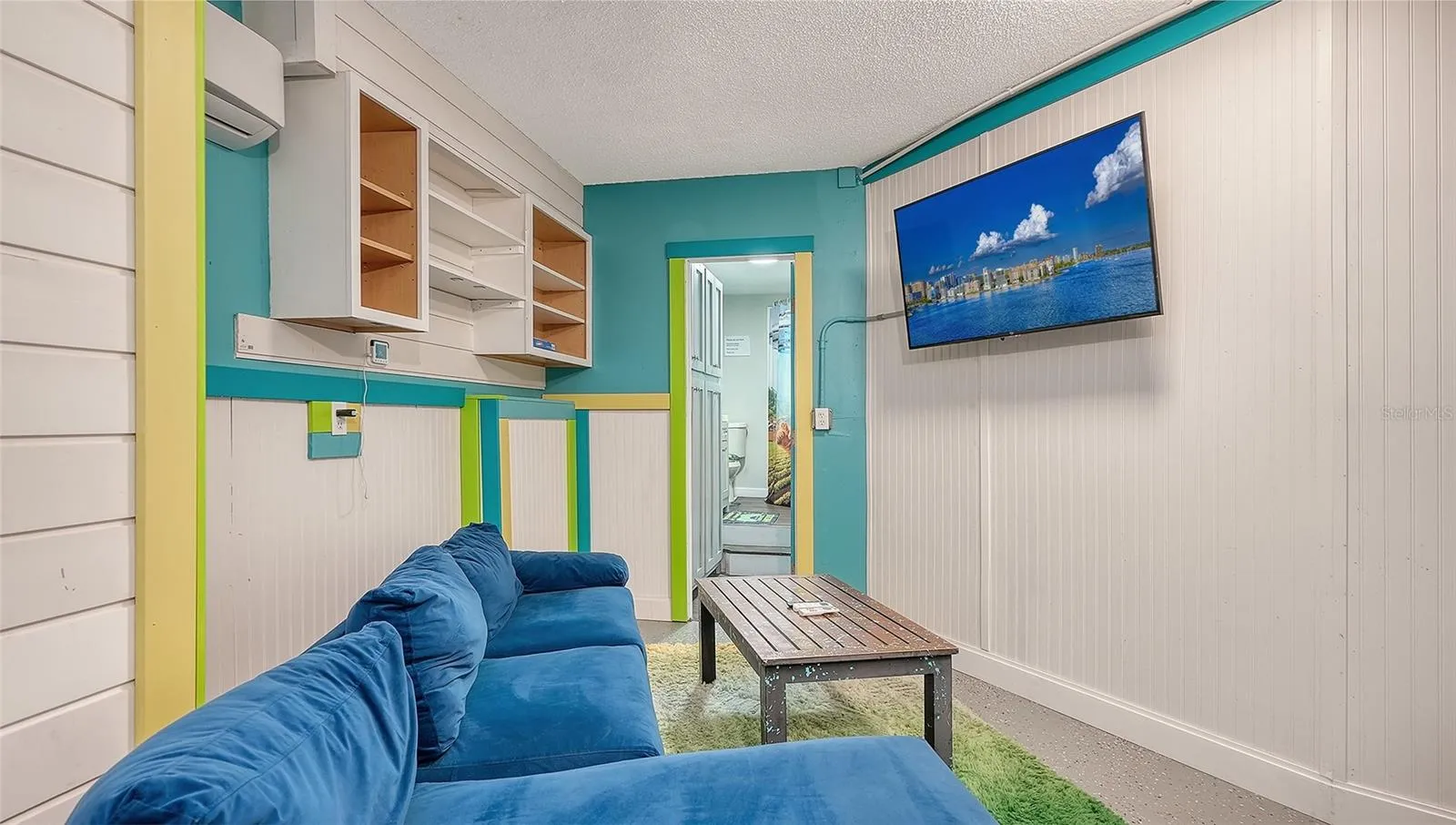 Ground floor under Unit B, converted garage to game or rec room/storage space.