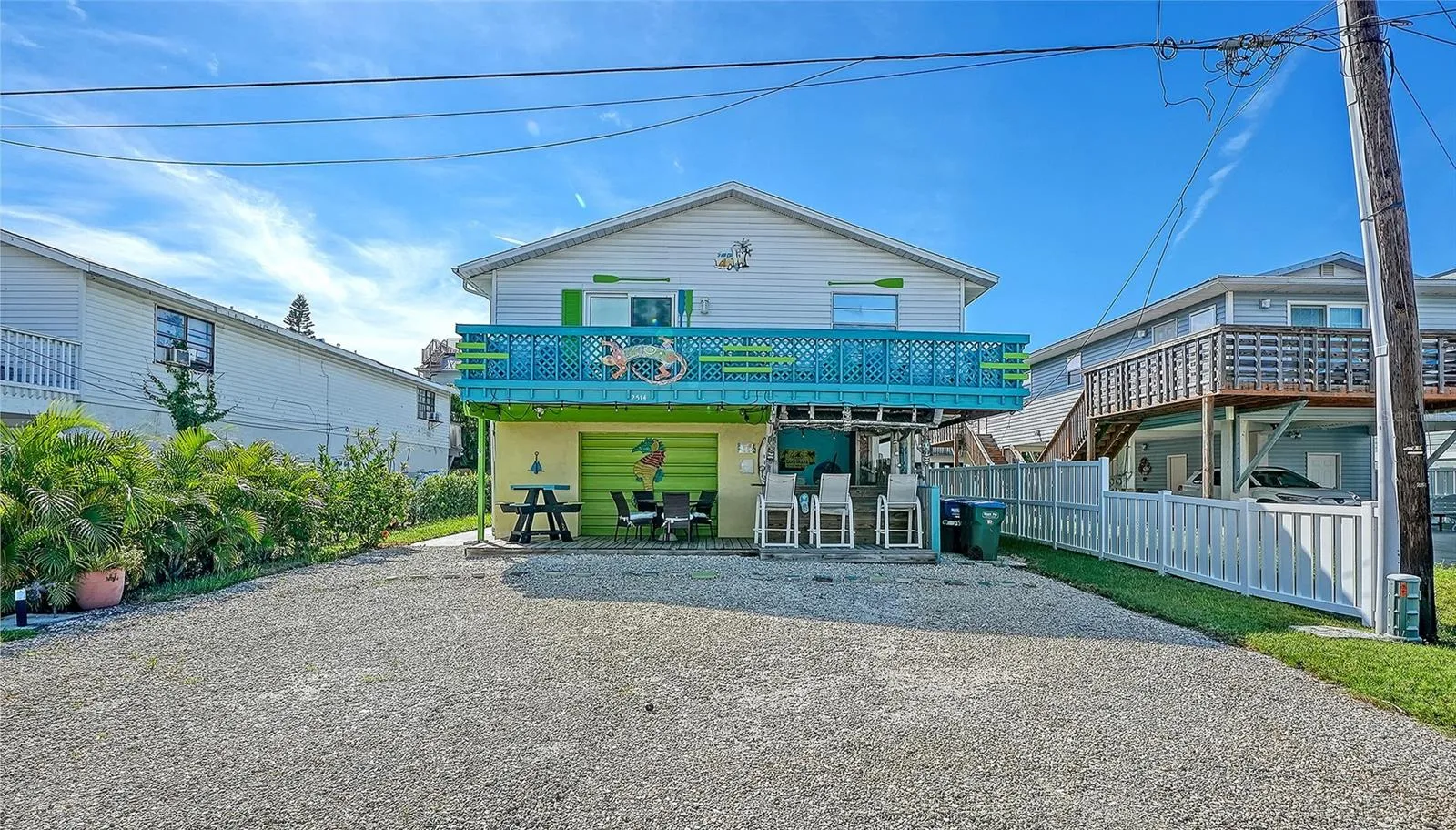 Front of 2514 Avenue B with gravel driveway with four assigned parking spaces.