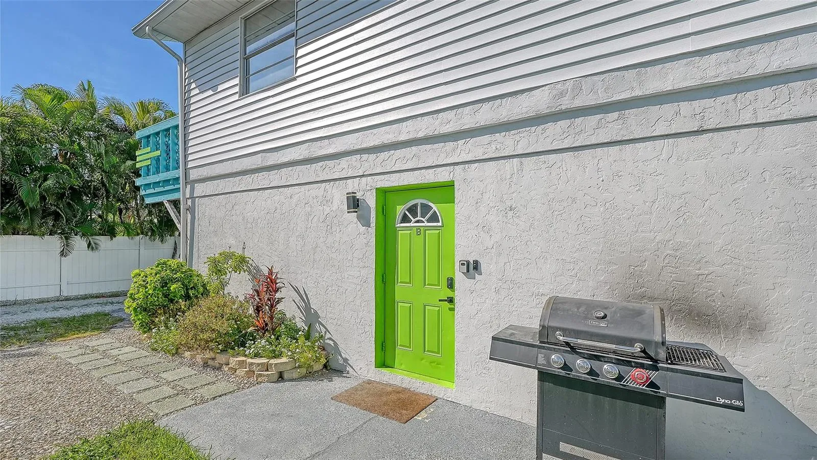 Both units have left side entrances. Green door, Unit B. Both units have a propane grill.