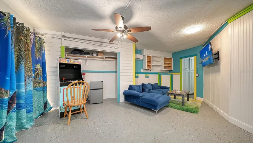 Ground floor under Unit B, converted garage to game or rec room/storage space.