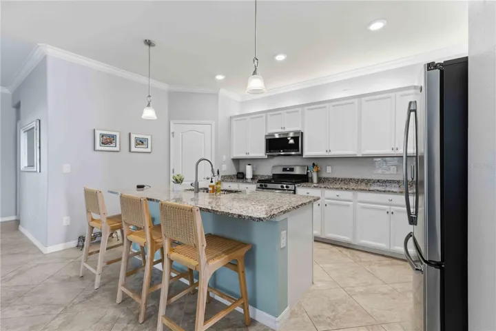 Granite Counters, Stainless GE and Bosch appliances-great walk-in pantry in corner. Natural gas range.