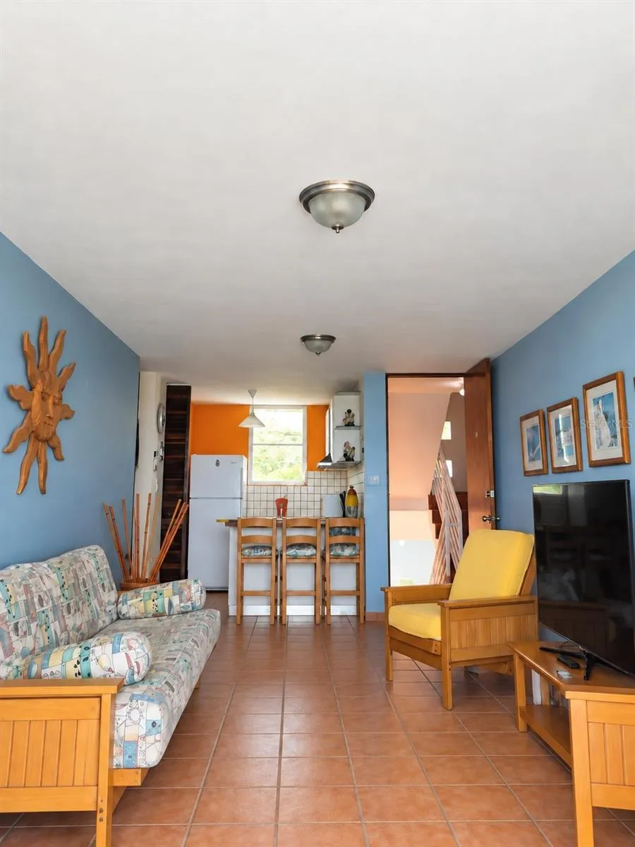 Kitchen, laundry and living room with the apartment main entrance.