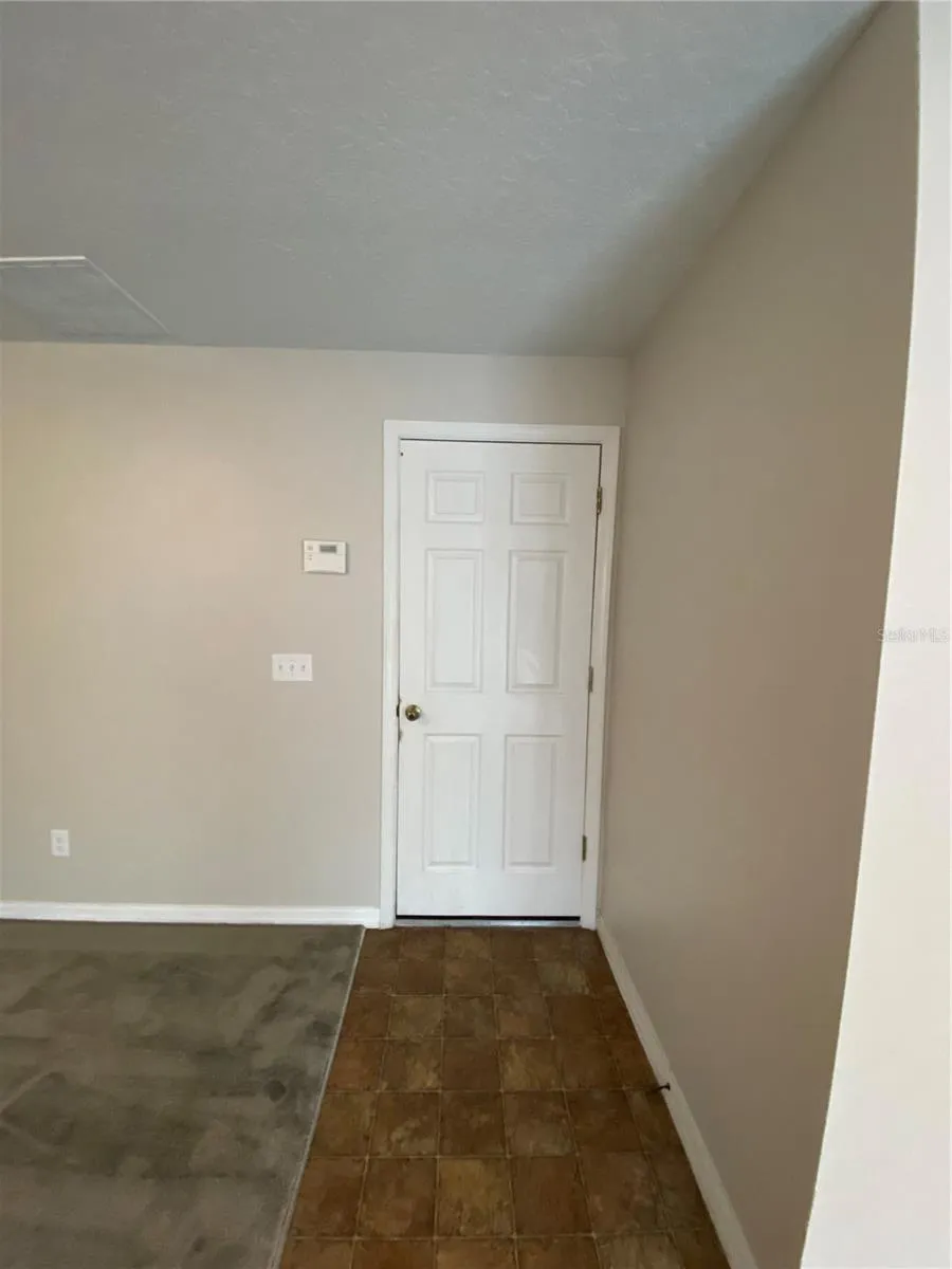 Door Leading to Garage within Family Room
