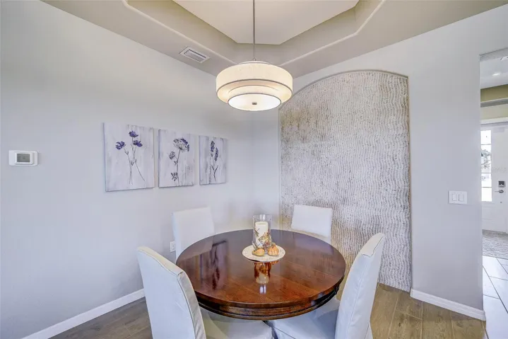 Dining area with custom tile feature wall