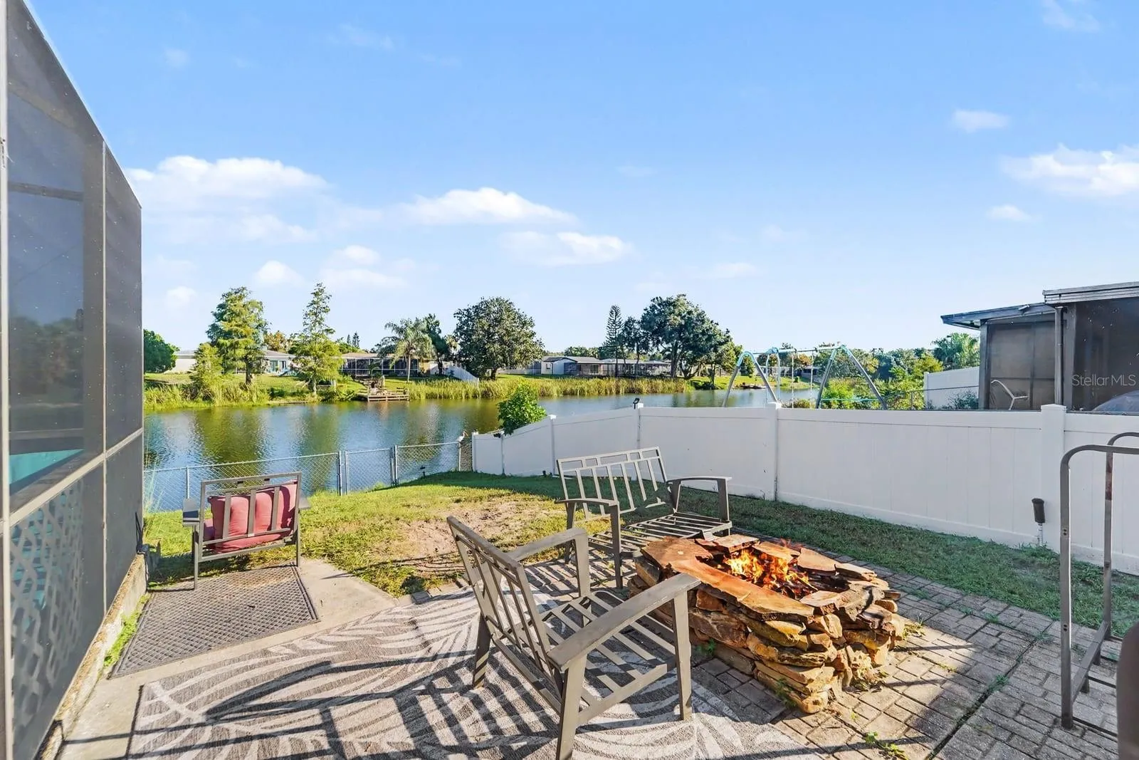 Waterfront Patio with Fire Pit & Lounge Seating Overlooking the Water