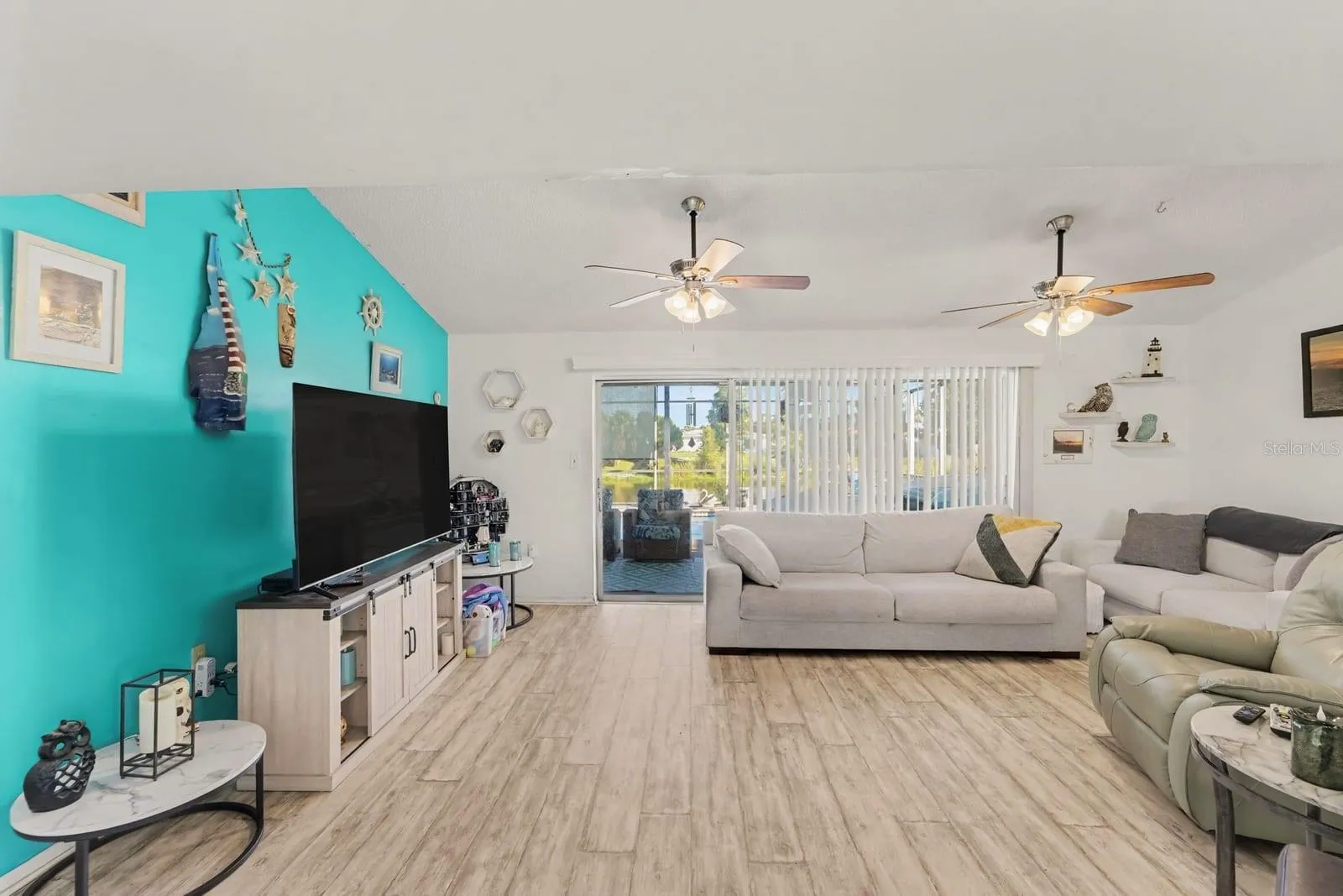 Expansive living space with multiple seating areas and water views