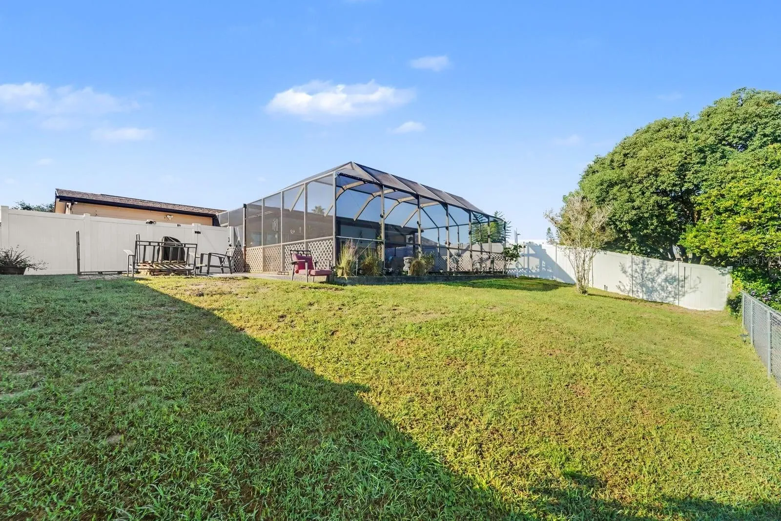 Large Lanai Enclosure with Screened Coverage & Lush Lawn Space
