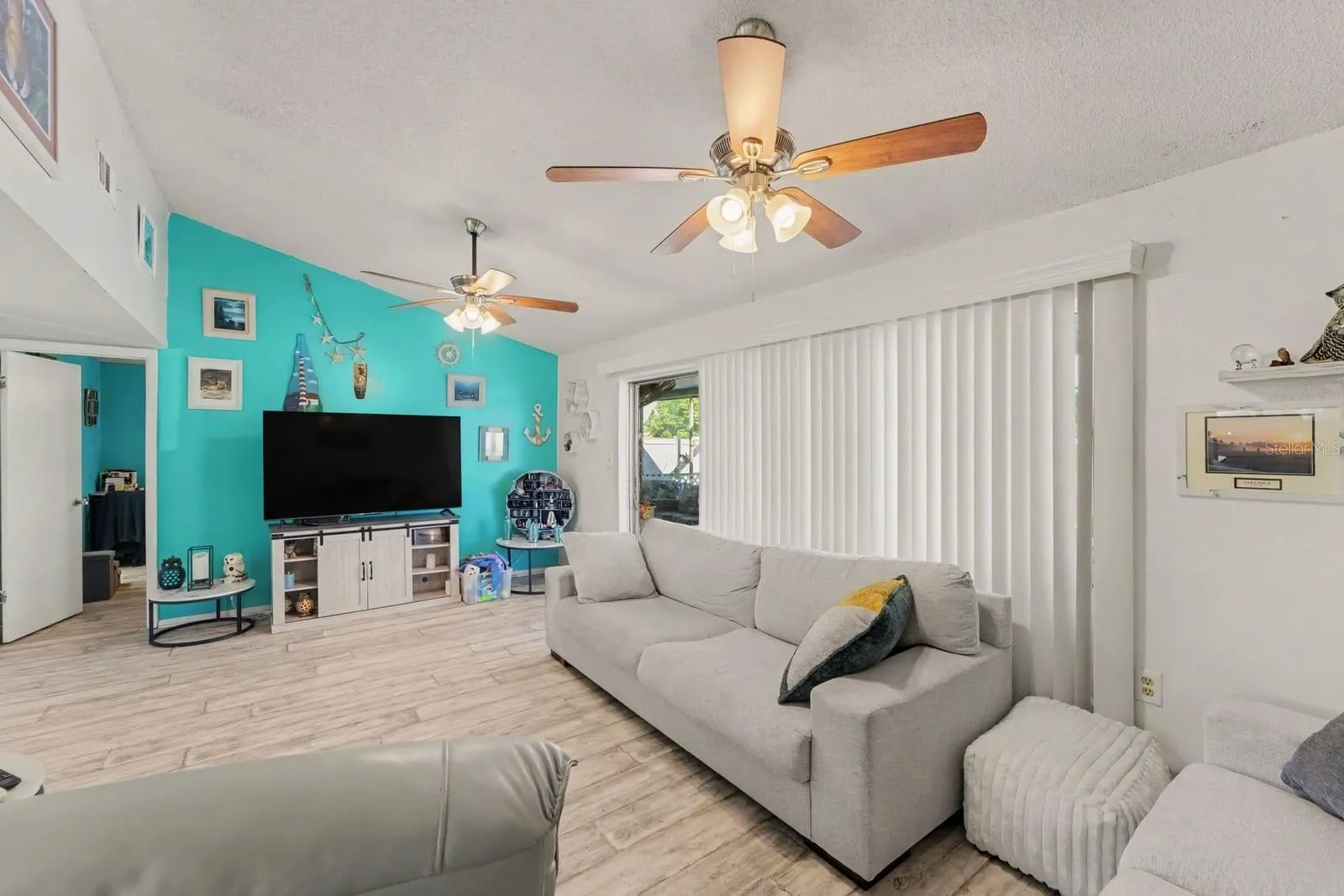 Spacious family room with turquoise accent wall and sliding glass doors