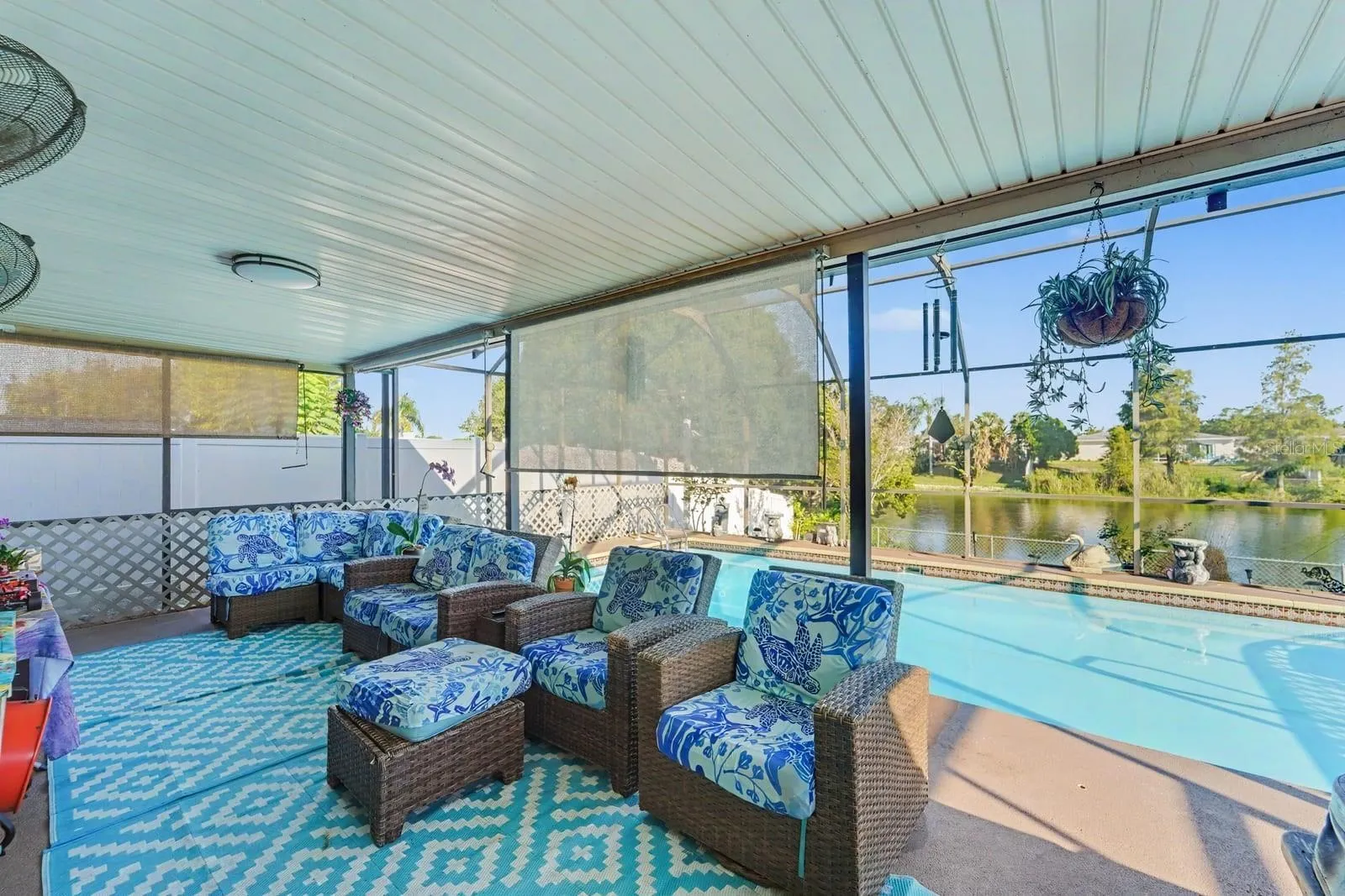 Screened Pool Lanai Overlooking Water, Wicker Seating & Blue & White Furnishings
