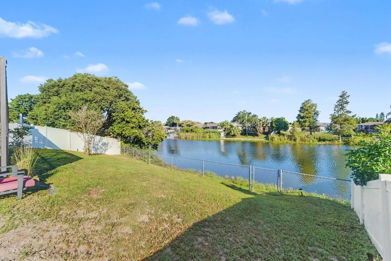 Expansive Backyard with Direct Waterfront Access & Fenced Perimeter