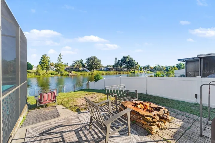 Waterfront Patio with Fire Pit & Lounge Seating Overlooking the Water