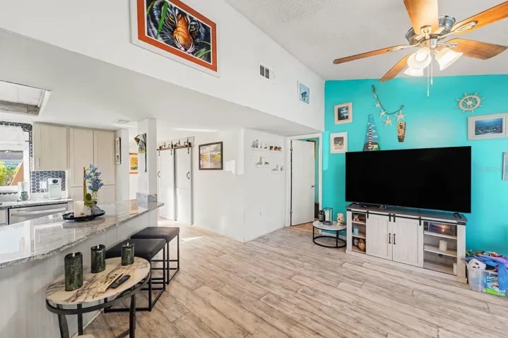 Open-Concept Living With Turquoise Accent Wall & Modern Entertainment Setup