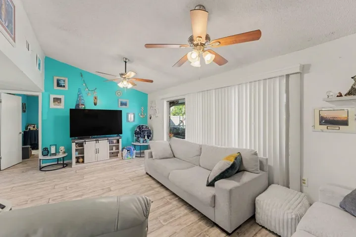 Spacious family room with turquoise accent wall and sliding glass doors
