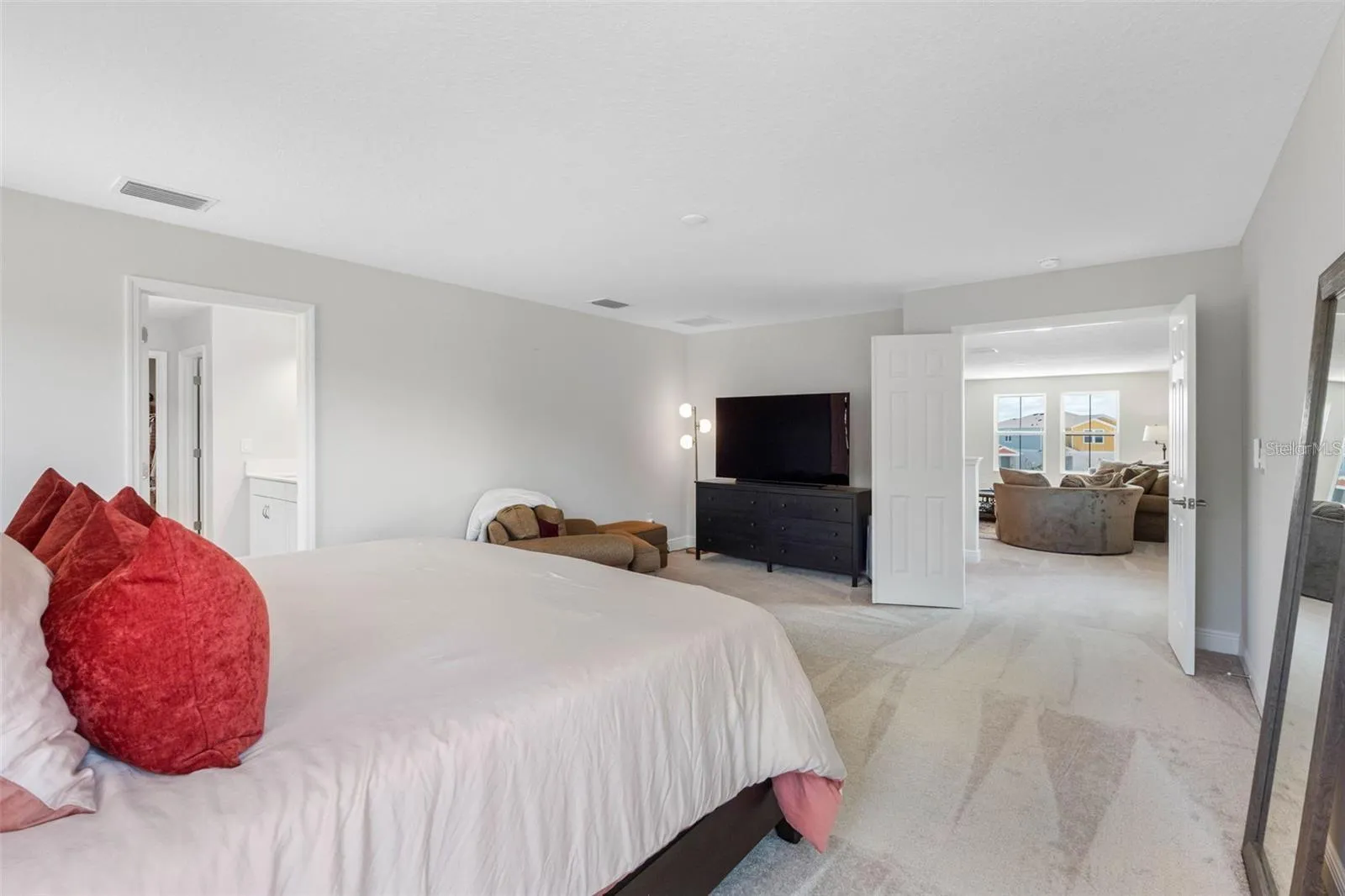Primary suite with double doors and room for a sitting area