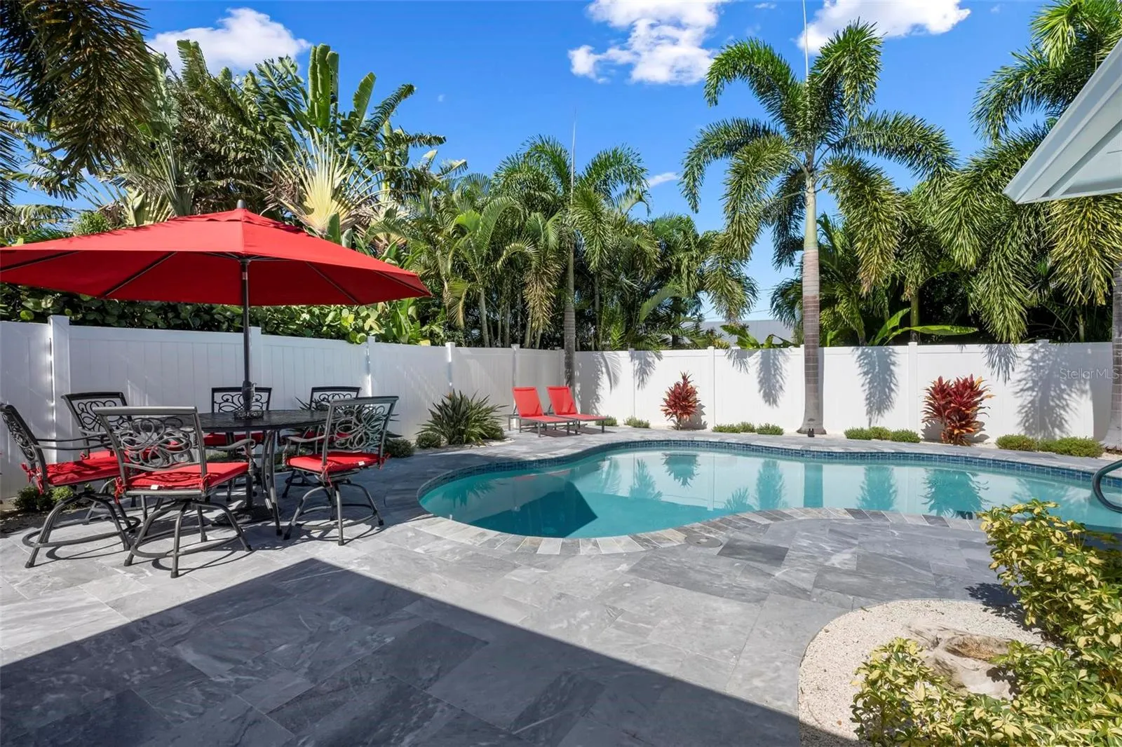 Pavered outdoor pool patio with heated saltwater pool