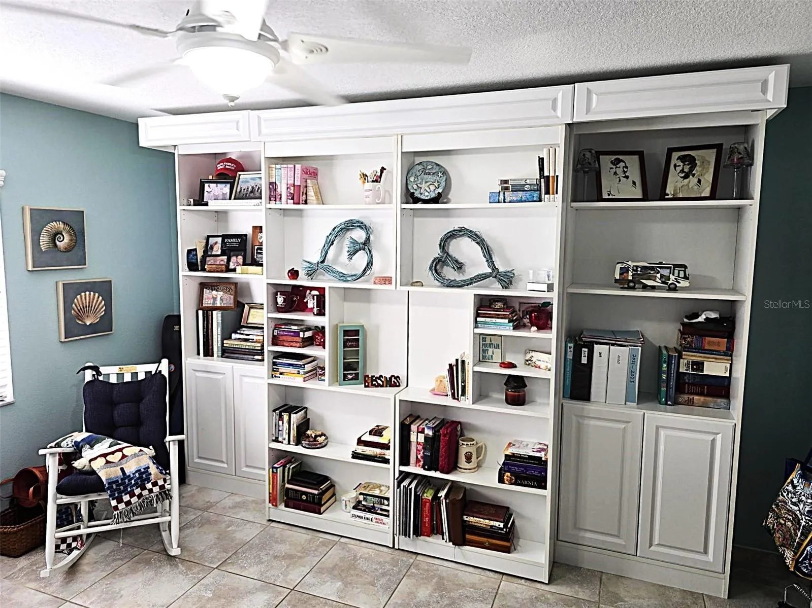 Library Style Murphy Bed shelving on rollers.