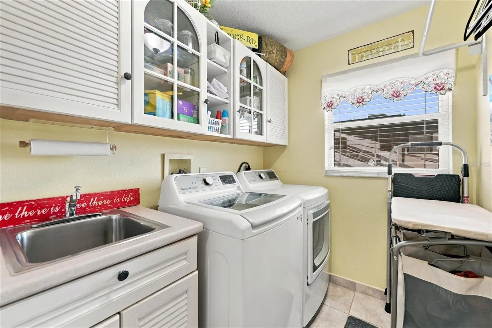 Interior laundry with storage.