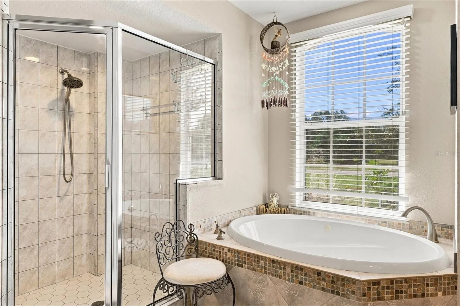 Primary bathroom with jetted tub and glass shower.