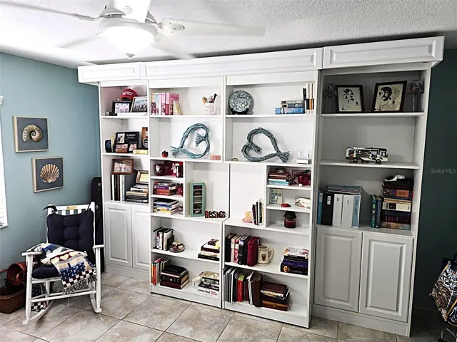 Library Style Murphy Bed shelving on rollers.