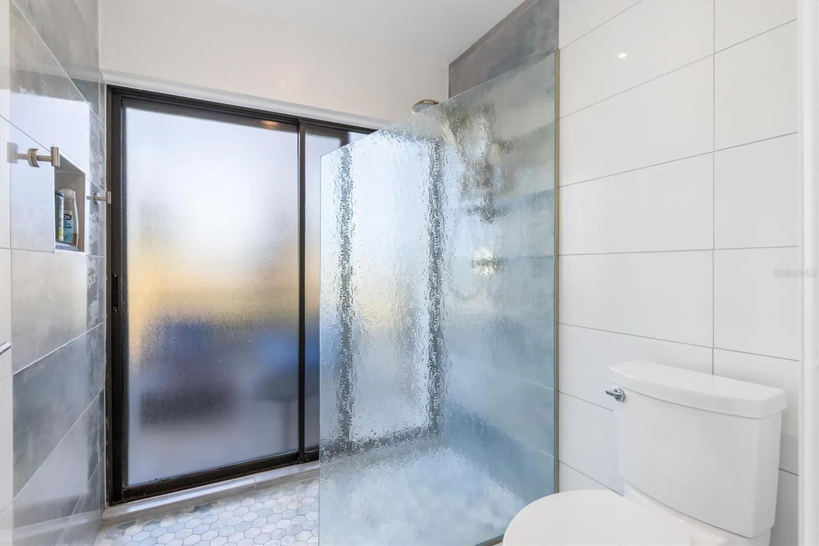 Glass shower and slider to lanai. Handy access for your hot tub.