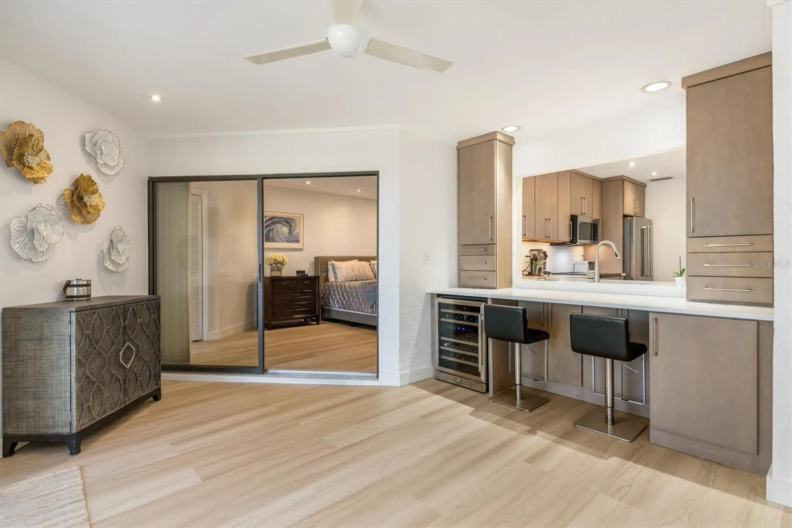 This area is designed for entertainment bar or office/computer area. Storage drawers on right have hidden electronic plugs and printer cabinet. On left end of bar is wine cooler and glassware cabinet.