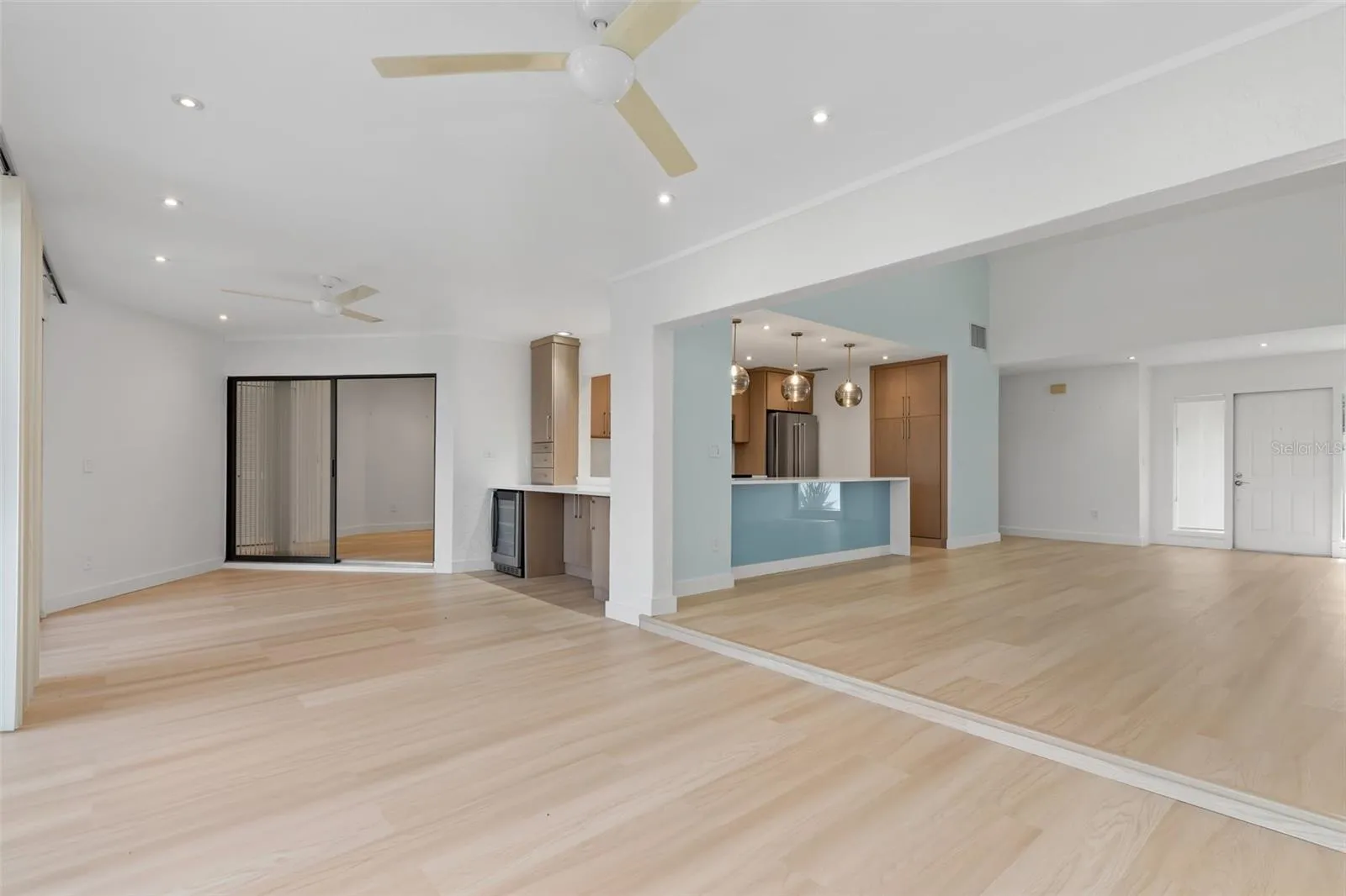 Standing at back sliders of family room and looking at open interior space. Dining, wine cooler, entertainment area.