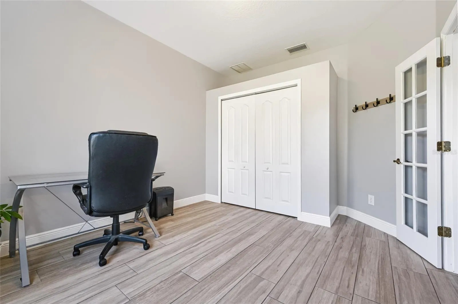 Spacious office with closet and French doors