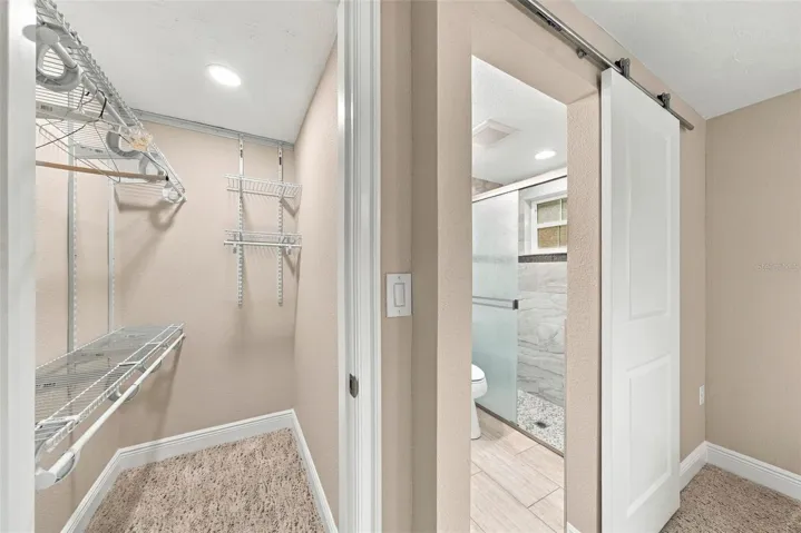 Primary bedroom walk in closet
