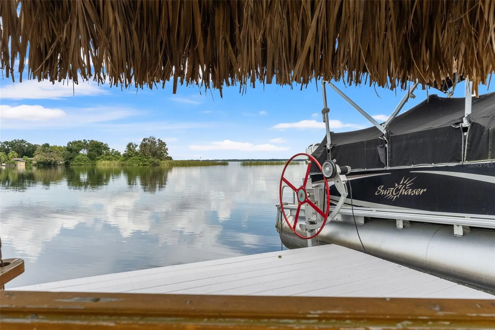Imagine relaxing beneath the thatched roof, enjoying a gentle breeze and uninterrupted views across the lake. This dockside seating area provides a peaceful escape just steps from your boat, bringing a little vacation atmosphere to everyday life.
