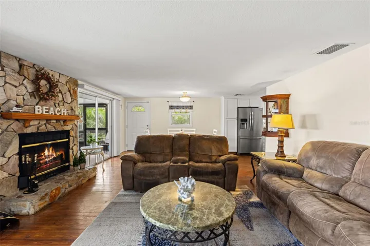 This is what waterfront living is all about! Sliding glass doors frame views of the screened porch, where a rocking chair invites you to sit back and enjoy the peaceful water, passing boats, and tropical surroundings.