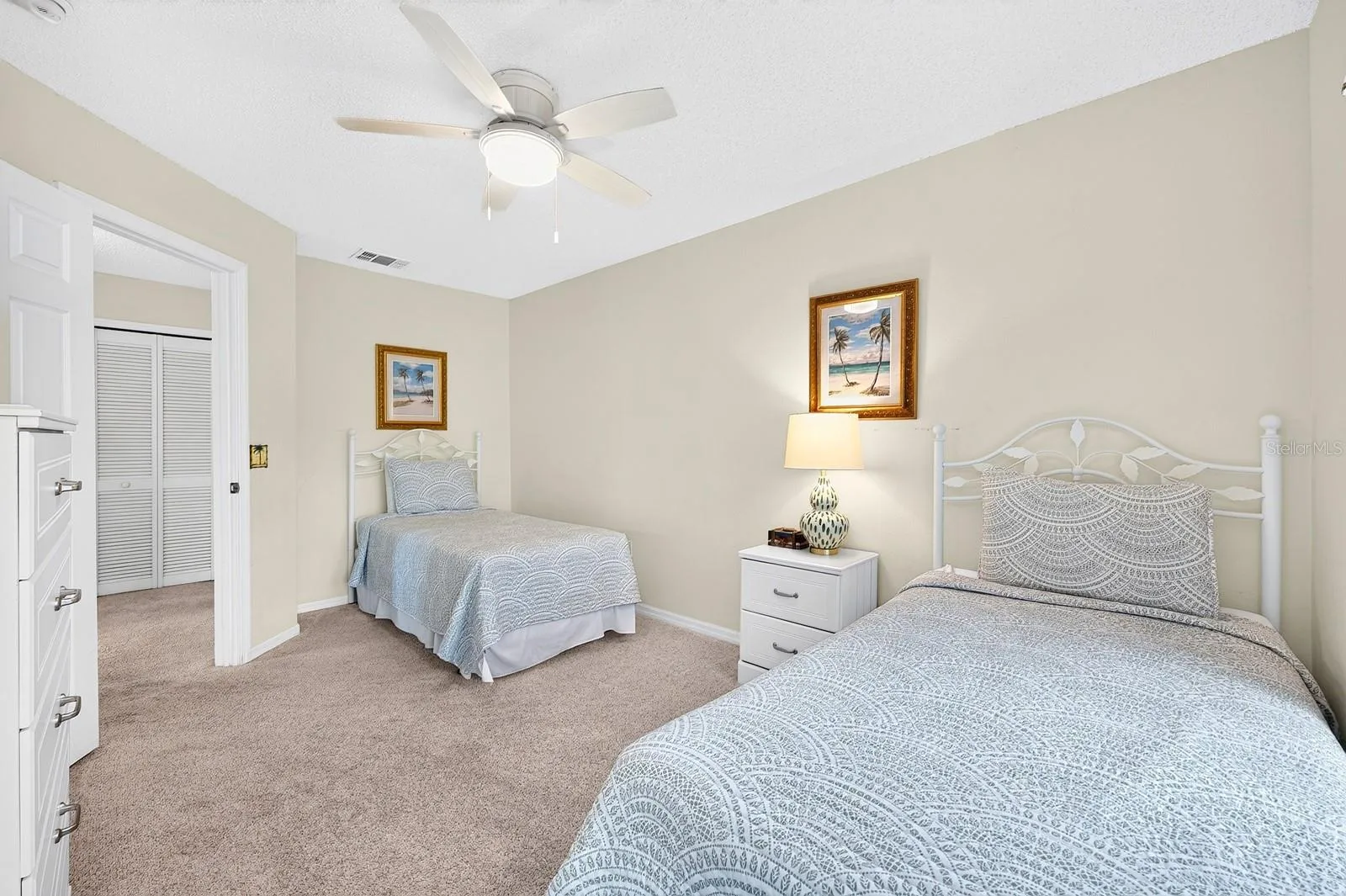 Bedroom 3 features an updated ceiling fan and furnishings.