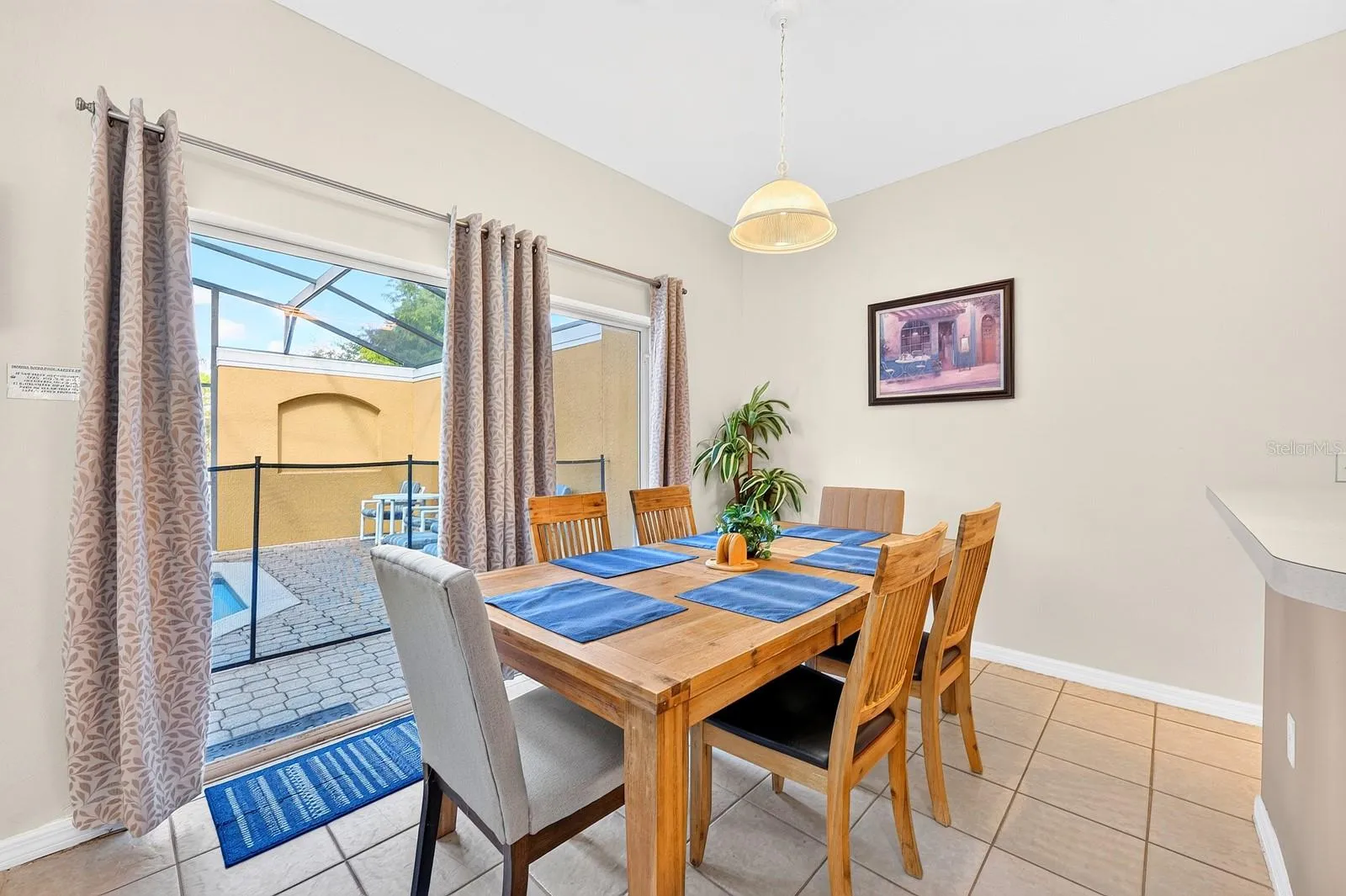Sliding glass doors in the Dining Area lead directly to the back PATIO AND POOL.