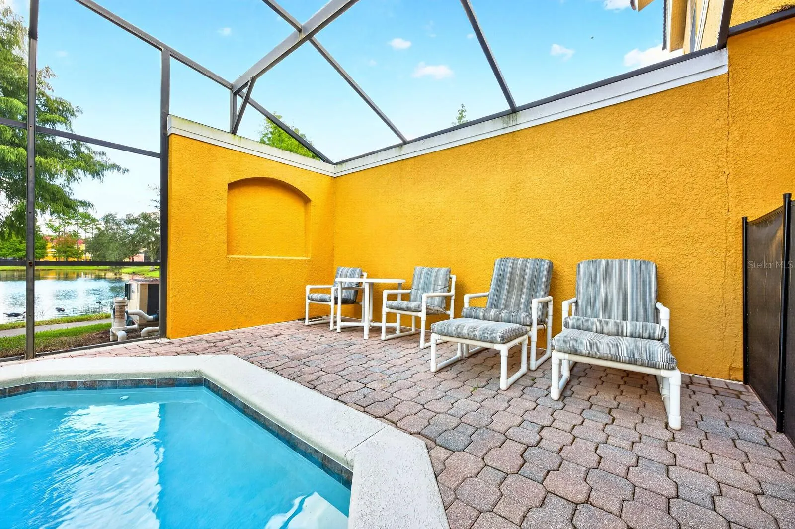 Step outside to your own PRIVATE SCREENED POOL and BRICK-PAVER PATIO.