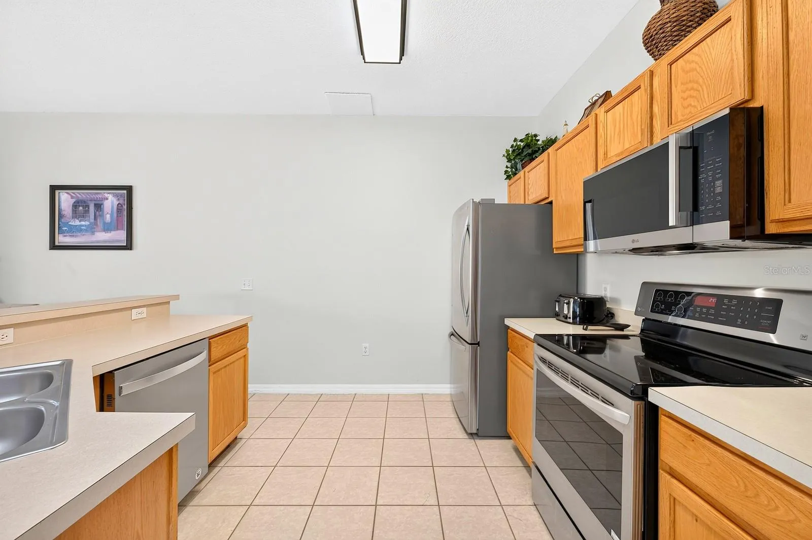 Updated stainless steel appliances enhance the space, including a NEWER MICROWAVE installed in 2024.