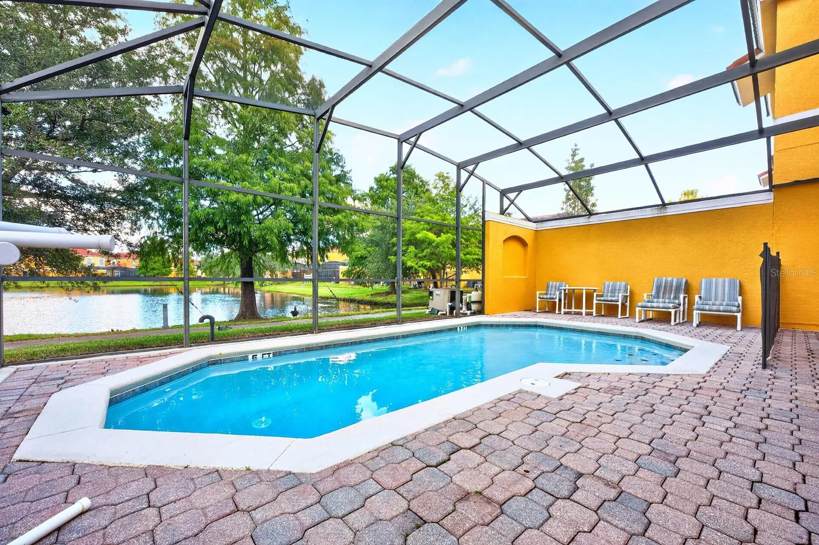 Tucked into a QUIET AREA of the community, the home offers a wonderful setting to unwind after a day of fun, with a PRIVATE SCREENED POOL.