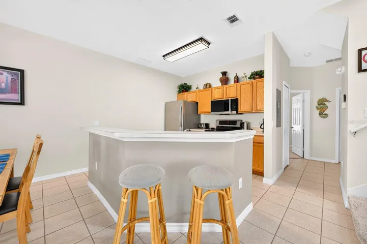 A center island and BREAKFAST BAR provide extra room for meal preparation, casual dining and conversation.