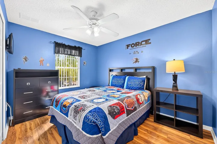 Bedroom 4 is enhanced with wood-look laminate flooring.
