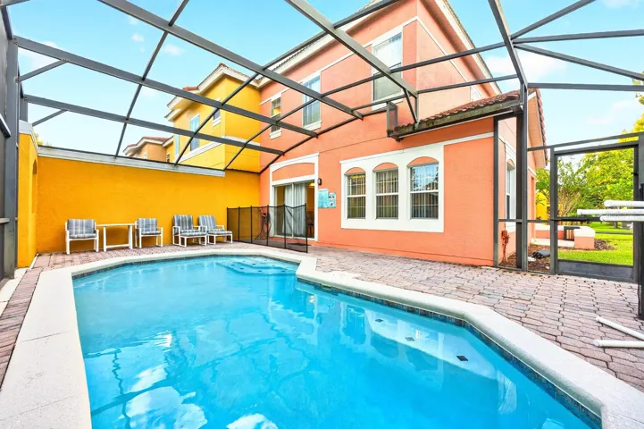 Step outside to your own PRIVATE SCREENED POOL and BRICK-PAVER PATIO.