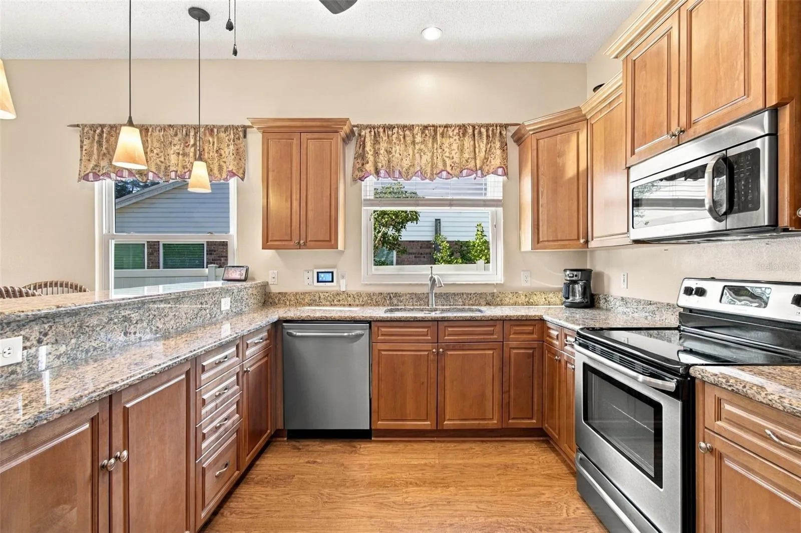 Kitchen open to Family Room with LVP, granite, breakfast bar