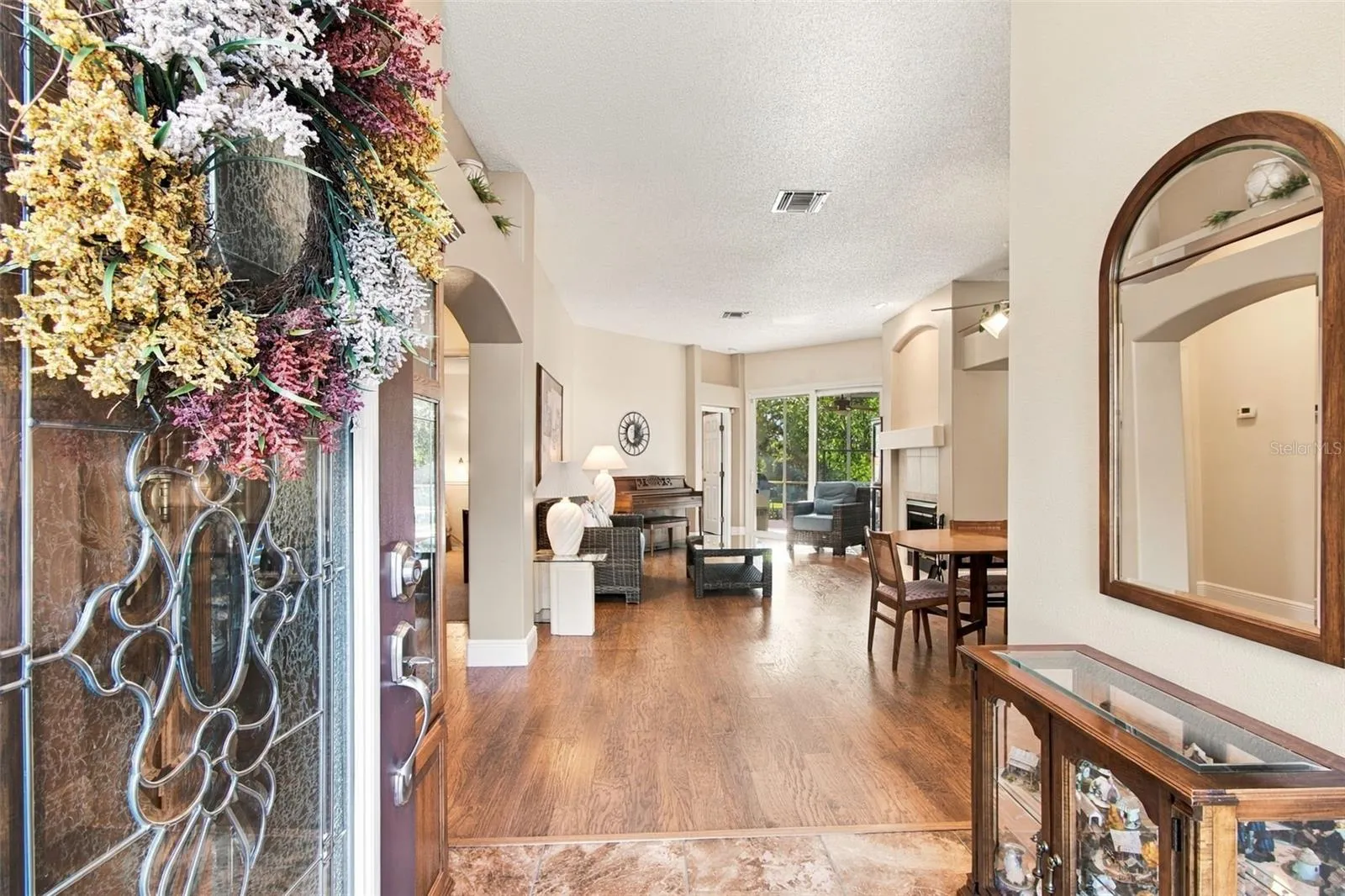 Welcome! View from Foyer to Living Room and Dining.  Hurricane sliders to lanai.